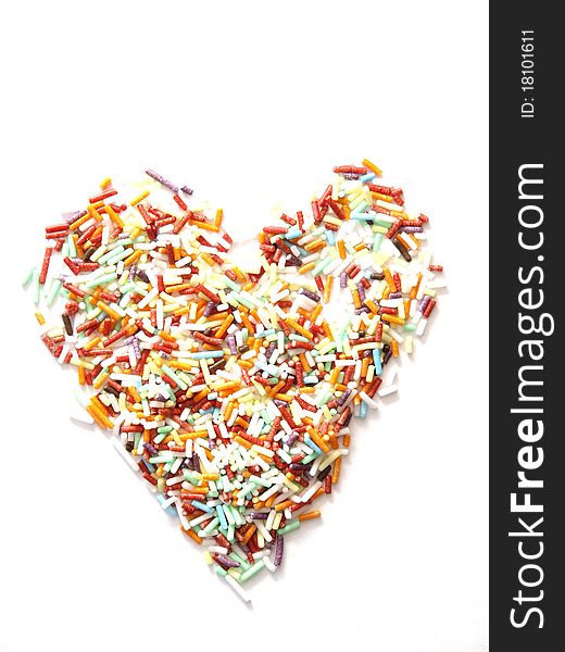 A colorful sprinkles in shape of a heart. A colorful sprinkles in shape of a heart