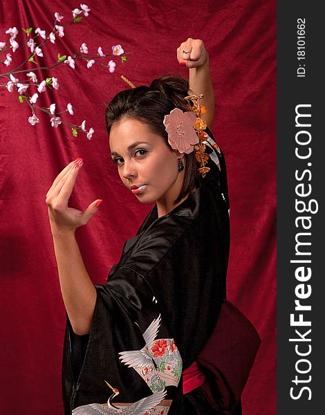 Japanese girl in traditional clothes posing to the camera