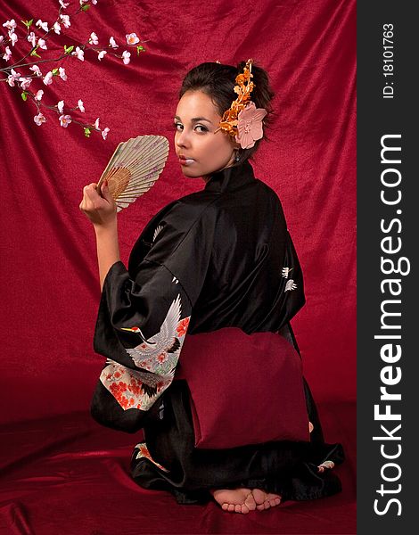 Japanese girl in traditional clothes posing to the camera