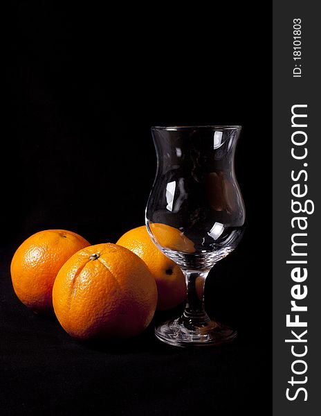 Glass of orange juice over black background