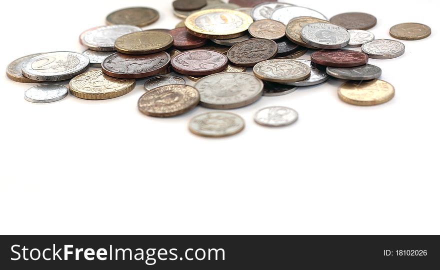 Metal coins from different countries on the table