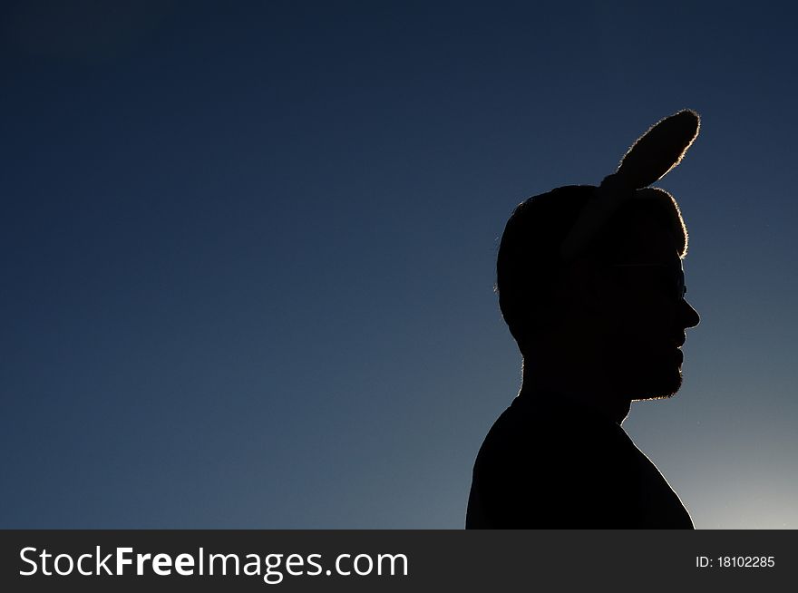 Silhouette of me wearing bunny ears against summer sky