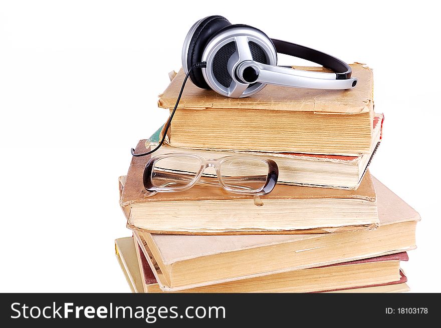 Books and headsets on a white background
