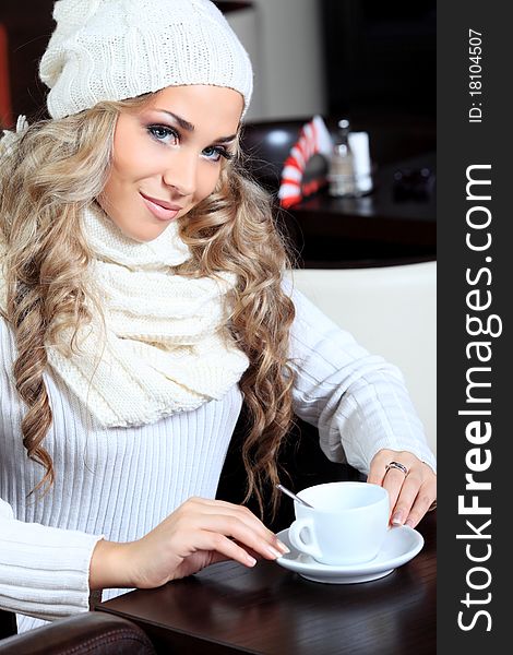 Beautiful young woman with a cup of tea at a caf. Beautiful young woman with a cup of tea at a caf