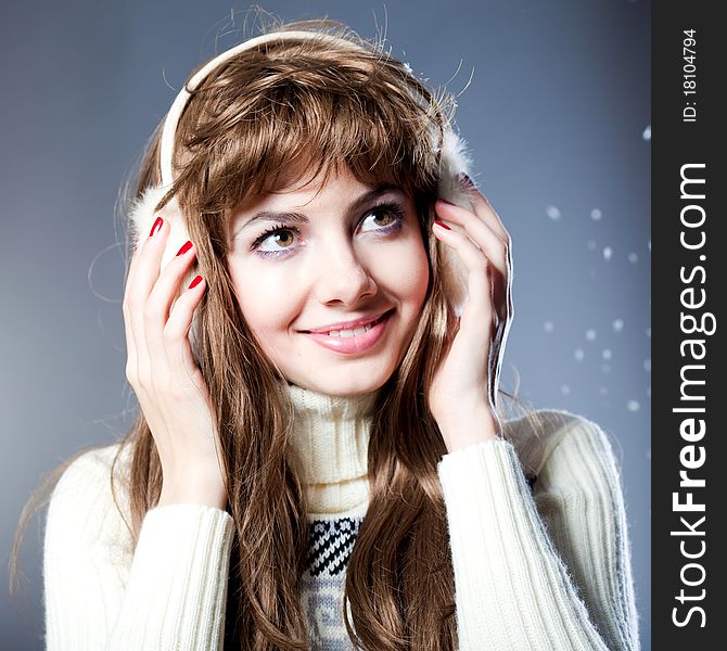 Young beautiful girl rejoices to snow, On a dark blue background