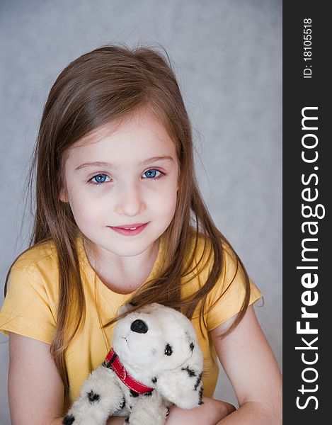 Portrait of little girl with toy dog