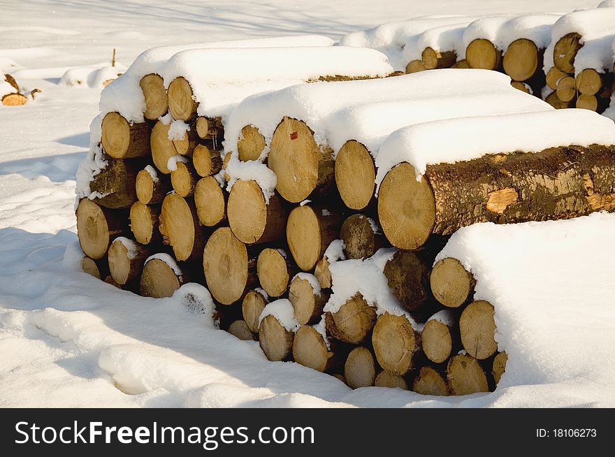 Wood piles in snow, traditional energy source