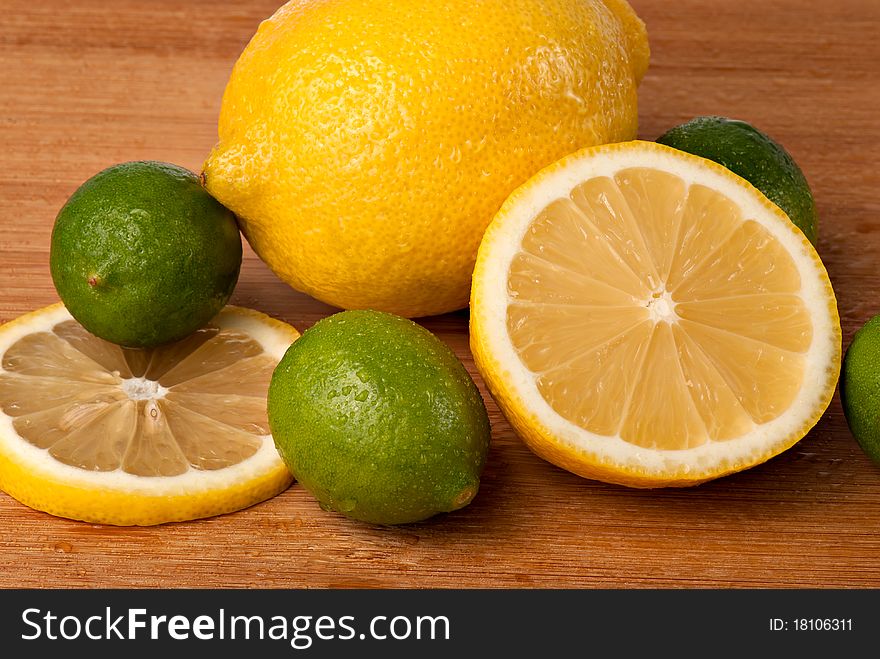 Close up of lemons and key limes with lemon slice. Close up of lemons and key limes with lemon slice