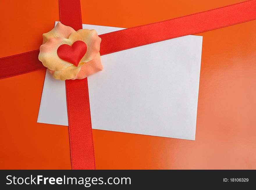 White card with rose petals. Postcard with heart on the orange background. Letter with a red ribbon. White card with rose petals. Postcard with heart on the orange background. Letter with a red ribbon.