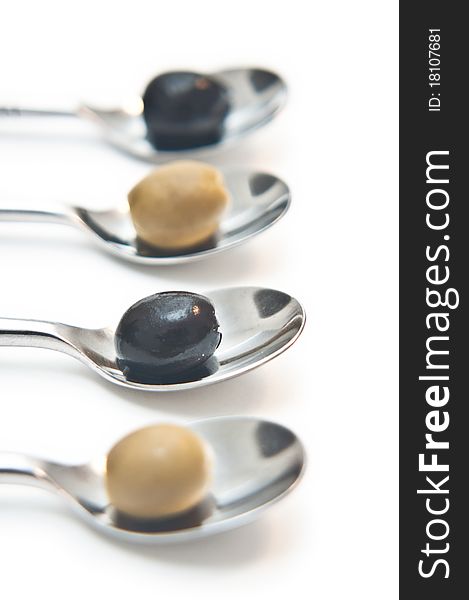Green olives presented on teaspoons. Green olives presented on teaspoons