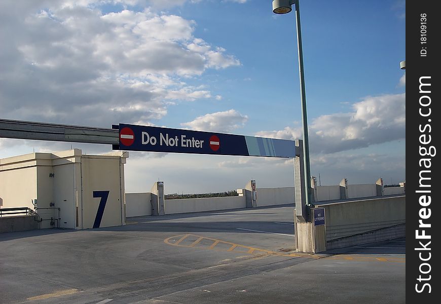 Roof top parking garage showing direction signage and upper ramp. Roof top parking garage showing direction signage and upper ramp