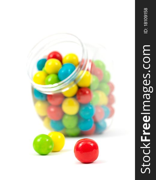 Gumballs in a jar isolated against a white background