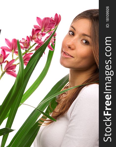 Brunette woman smelling purple orchid flower