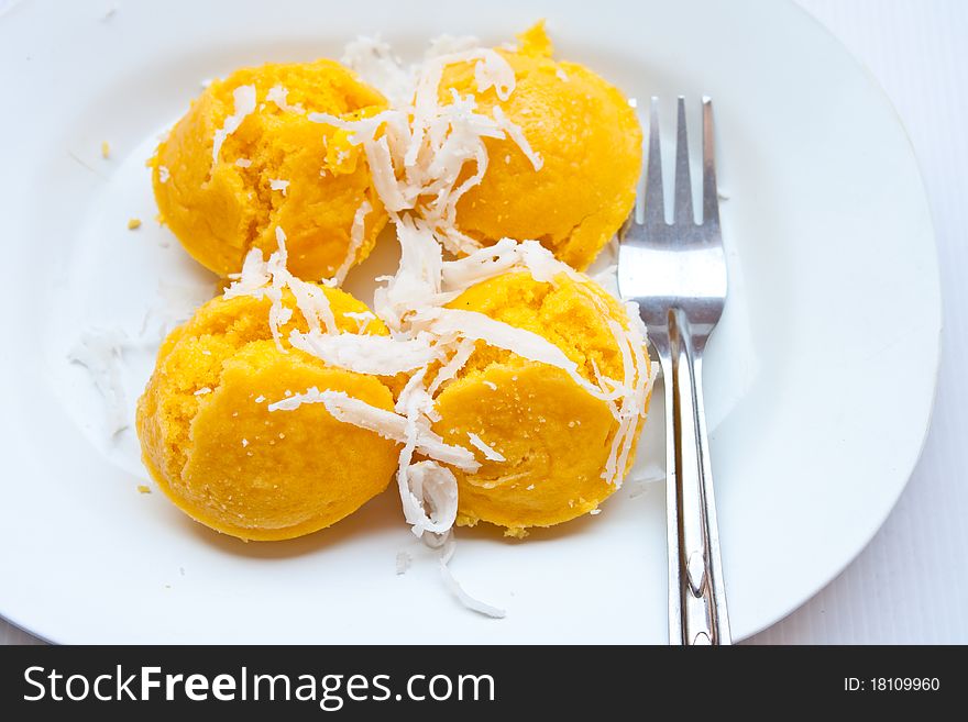 Dessert thai sweet sugar palm cake with coconut On a white plate