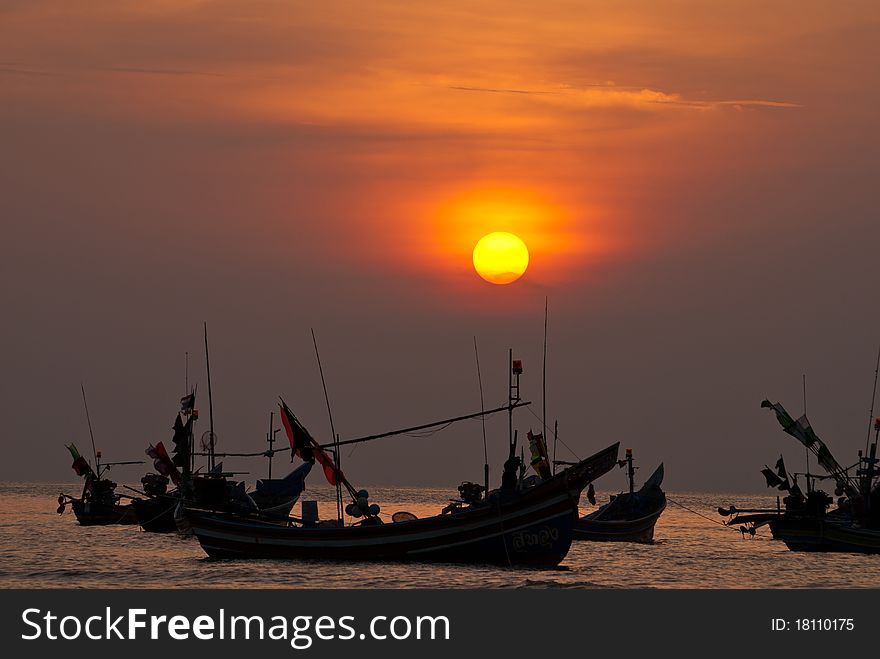 Sunset view with fisherman boats foreground.rn