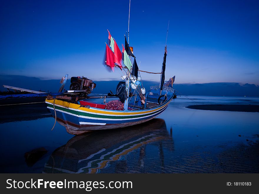 Fisherman boat at twilight with long exposure technique.