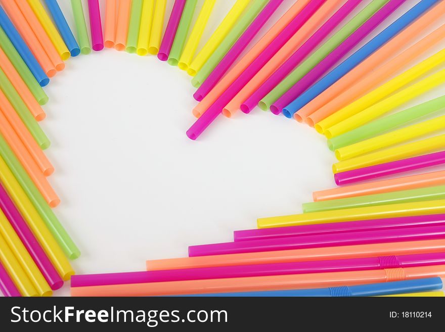 A heart made from colorful straws on a white background. A heart made from colorful straws on a white background.