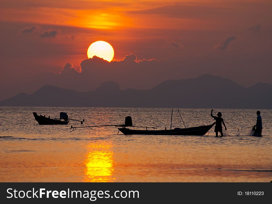 Two of young fisherman working at sunset. Two of young fisherman working at sunset.