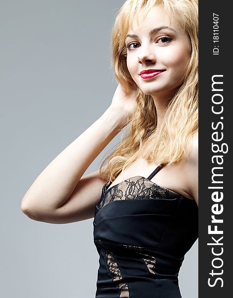 Young beautiful high blonde in a black dress