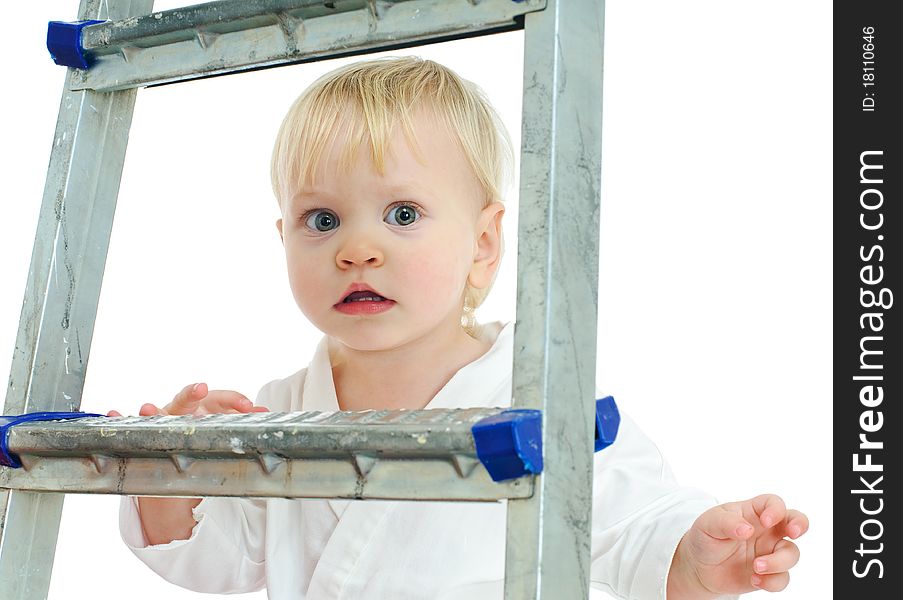 Little boy in kimono on step ladder and white background