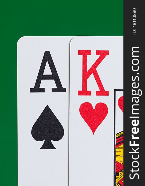 Close up of Ace and King playing cards on a green background