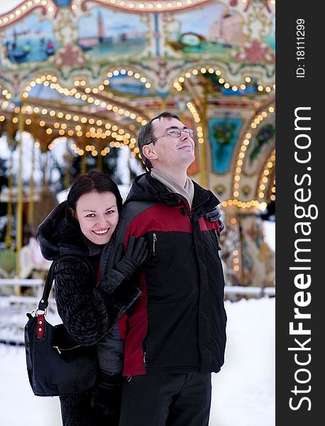 Happy Couple Looking At Carousel