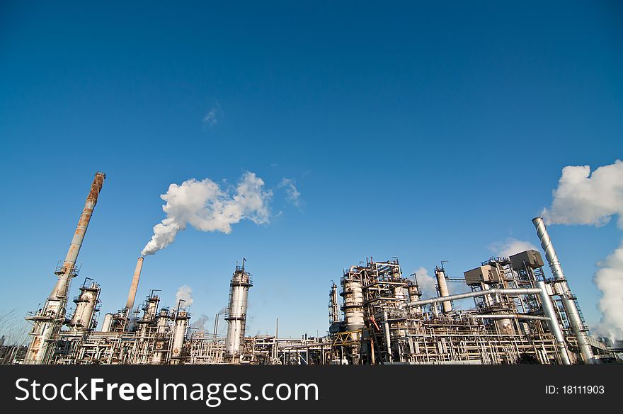 A petrochemical refinery plant with pipes and cooling towers.
