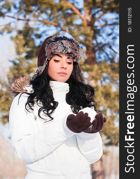 A young beautiful girl on a walk in a winter park, winter, snow, forest.