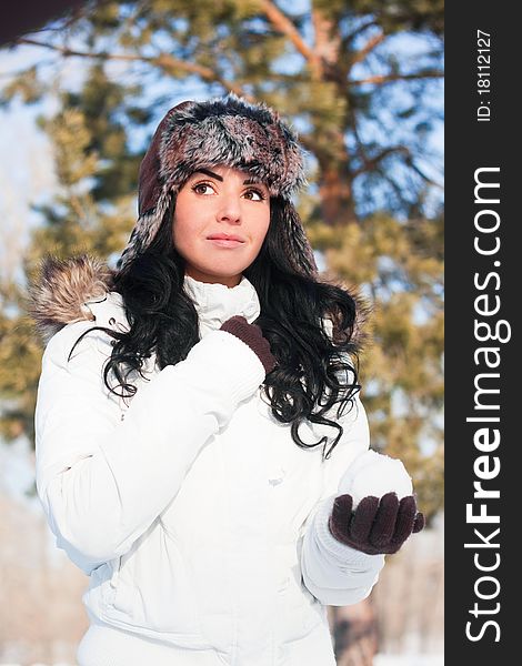 A young beautiful girl on a walk in a winter park, winter, snow, forest.