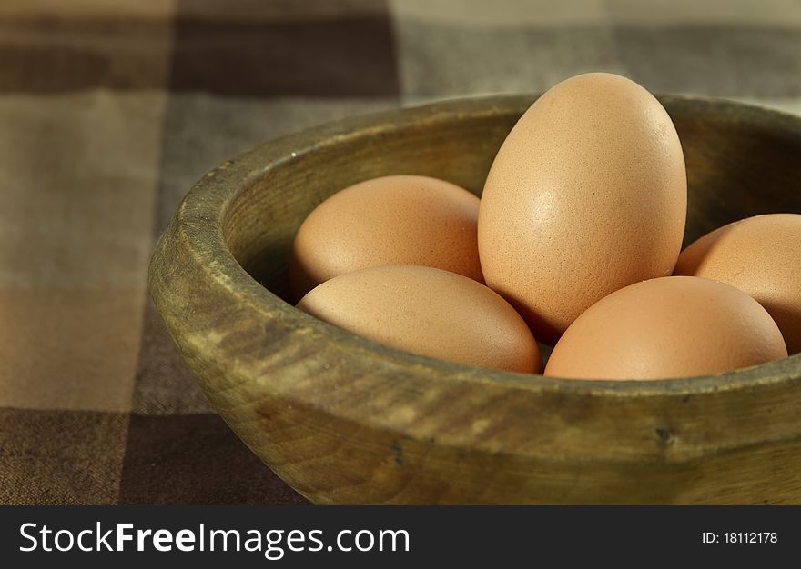 Pile of eggs in a wooden bowl