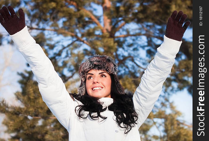 A young beautiful girl on a walk in a winter park, winter, snow, forest.