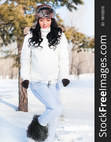 A young beautiful girl on a walk in a winter park, winter, snow, forest.