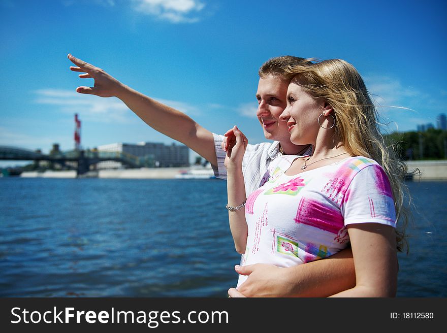 Young man show his girlfriend that in the distance on sky