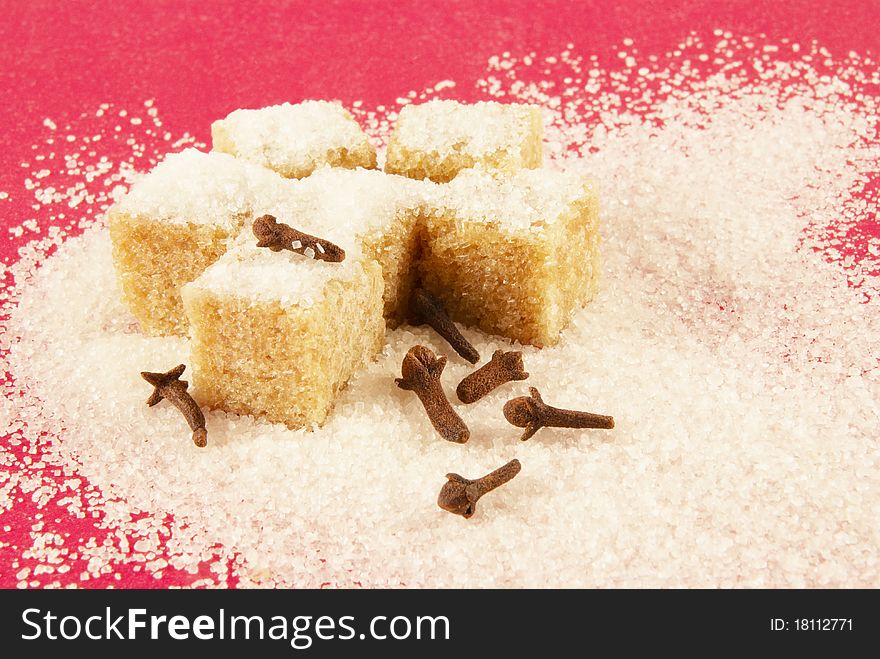 Blocks of brown sugar, spicinesses on a red background. Blocks of brown sugar, spicinesses on a red background