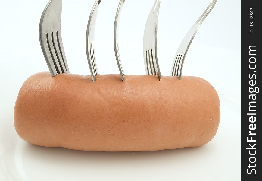 Five metal plugs thrust in an ode appetizing sausage. Five metal plugs thrust in an ode appetizing sausage