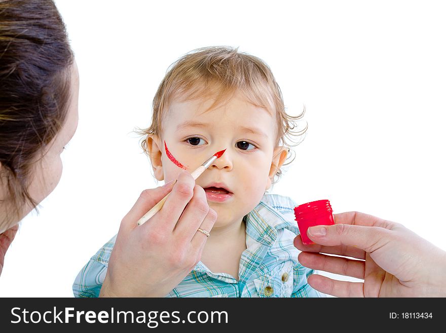 Beautiful baby covered in bright paint with paint brush. Isolated.