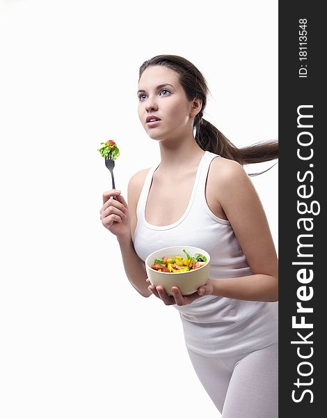 Attractive girl running with a plate of salad on a white background. Attractive girl running with a plate of salad on a white background
