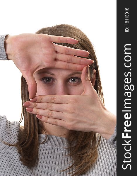Young woman in grey sweater with hands frame isolated over white background