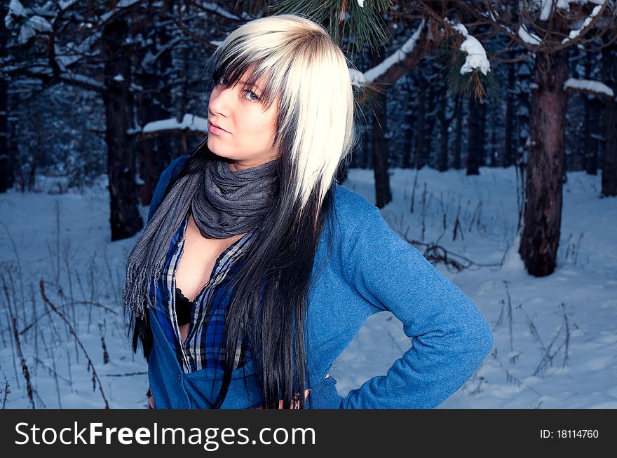 Beautiful girl in spruce forest at winter. Model watched in a camera.