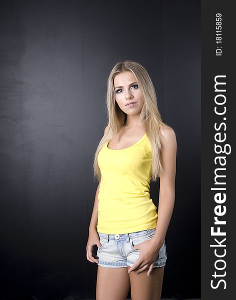 Girl in a yellow vest, on a black background,