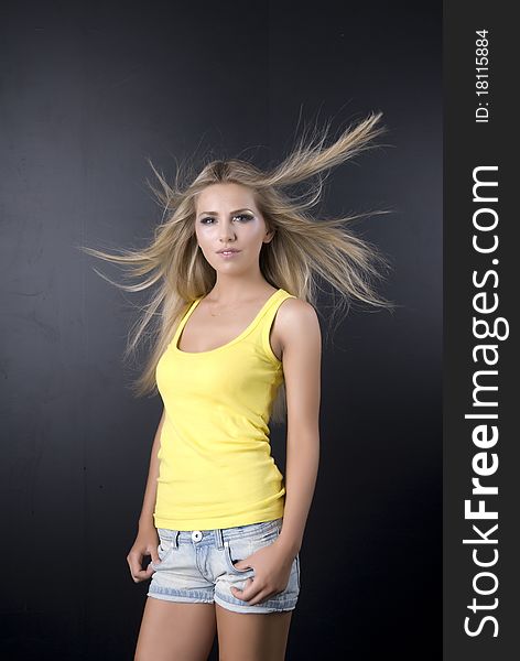 Girl in a yellow vest, on a black background,