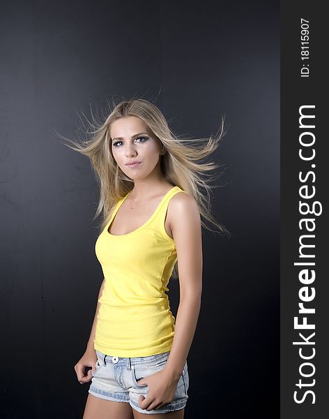 Girl in a yellow vest, on a black background,