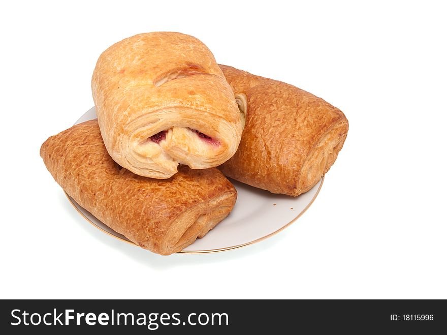 Three puff pies on a porcelain plate. On a white background. Three puff pies on a porcelain plate. On a white background