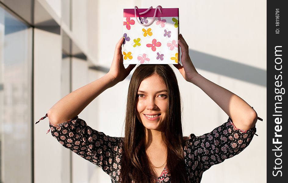 Attractive brunette young woman with a paper bag. Attractive brunette young woman with a paper bag