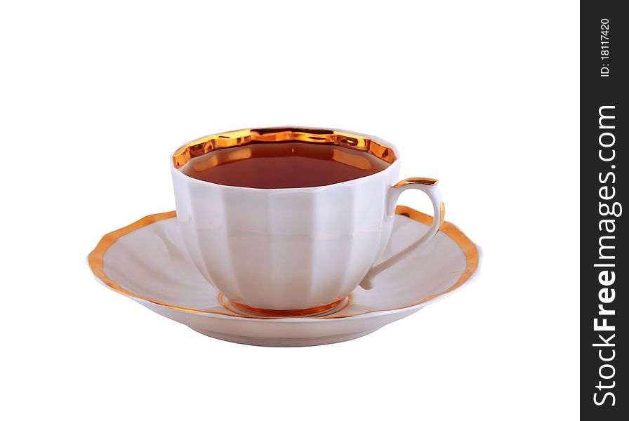 Cup of black tea on a saucer isolated on white. Cup of black tea on a saucer isolated on white