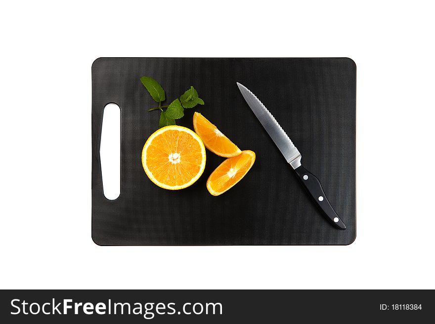 Black cutting board with oranges, mintleaf and knife isolated on white background. Black cutting board with oranges, mintleaf and knife isolated on white background