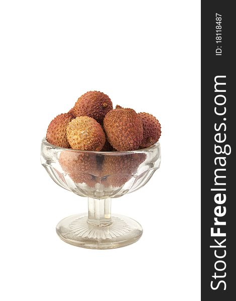 Lychees in glass vase isolated on white background