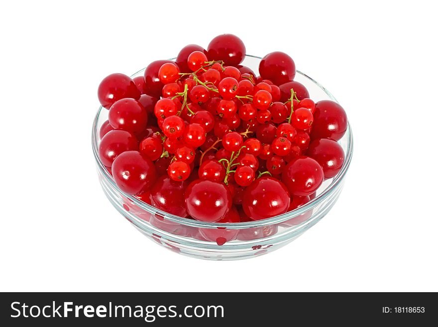 Sweet cherries and currants in glass bowl isolated on white