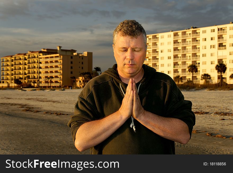 Man Praying In Front Of Hotels