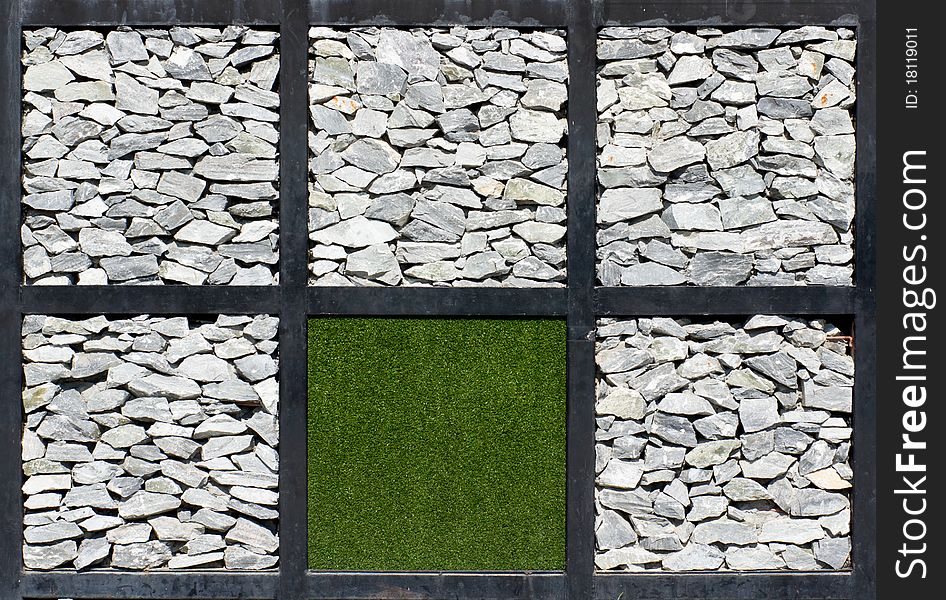 Real rock and artificial grass wall